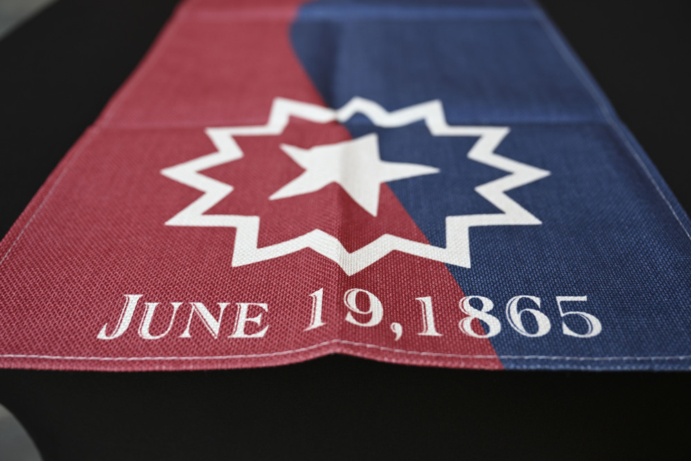 Juneteenth flag, half red, half blue with a star in the center