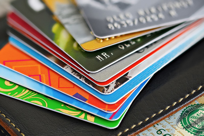 credit cards of several colors stacked in a pile